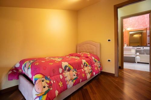 a bedroom with a bed with a blanket with animals on it at Casa Sonia in Castiglion Fiorentino