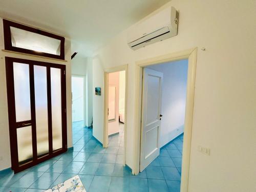 a hallway with two doors and a tile floor at Alba Chiara Sperlonga in Sperlonga