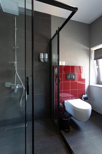 a bathroom with a shower and a toilet and a sink at Abone Suites in Istanbul