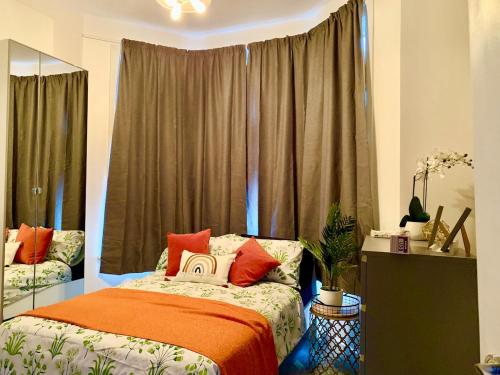 a bedroom with a bed and a large window at Amazing Double Ensuite Room in Erith