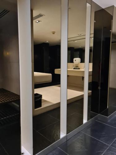 a room with two beds and a mirror at Comfortable Zone in Klong Toi