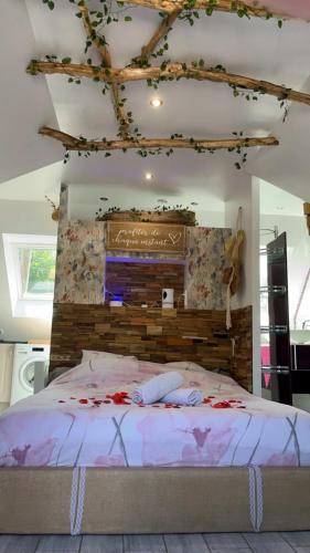 a bedroom with a large bed with flowers on it at La Plumeria in Baincthun