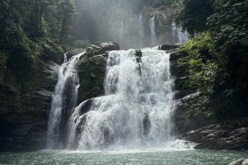 a waterfall in the middle of a river at Eco Luxe Glamping Nest #4 - 2 Queen Beds at Holos in Barú