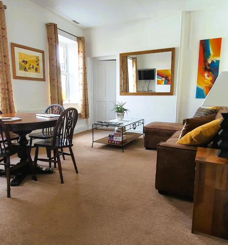 a living room with a table and a couch at Station Cottage Hawes in Hawes