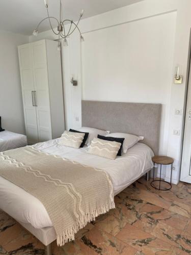 a bedroom with a large bed with white sheets and pillows at Villa W in Cassis