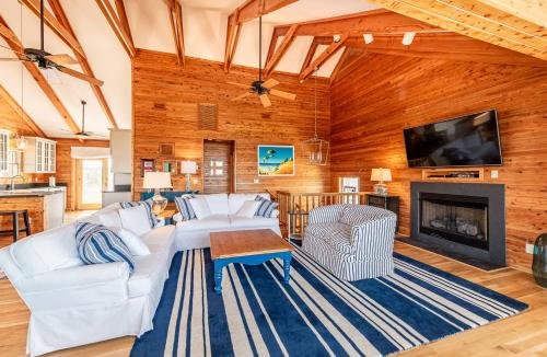 a living room with a white couch and a fireplace at Shore Enough in Sanderling