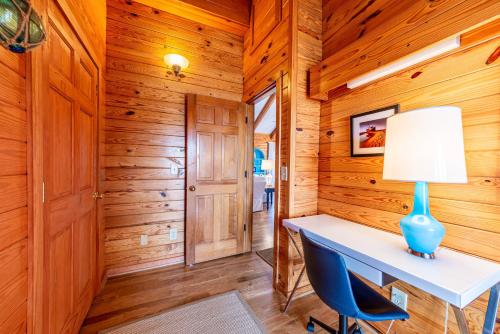 a home office with a desk and a lamp at Shore Enough in Sanderling
