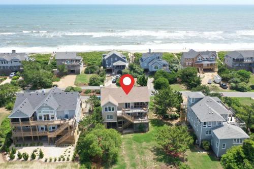 an aerial view of a home with a red marker on it at Shore Enough in Sanderling