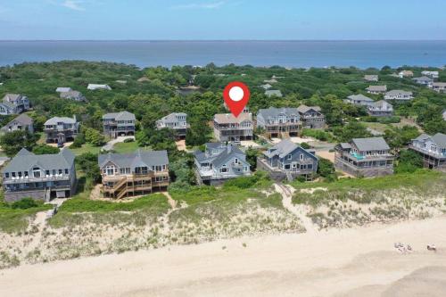 a house with a red marker on the beach at Shore Enough in Sanderling