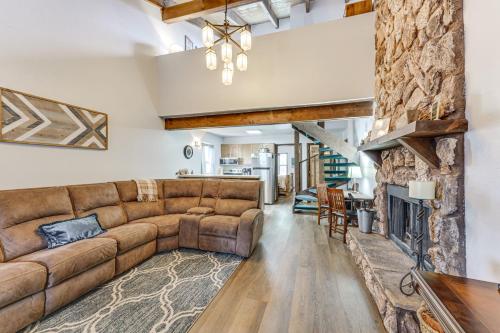 a living room with a couch and a fireplace at Pet-Friendly Angel Fire Condo Walk to Ski Resort in Angel Fire