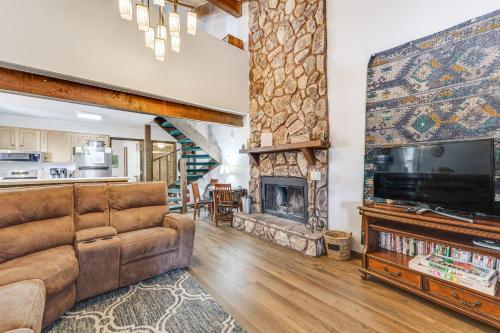 a living room with a couch and a fireplace at Pet-Friendly Angel Fire Condo Walk to Ski Resort in Angel Fire