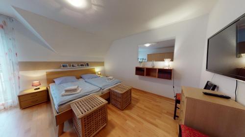 a small room with a bed and a flat screen tv at Emara in Borkum