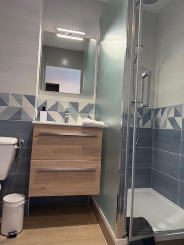 a bathroom with a shower and a sink and a toilet at Les Jardins d'Oléron in Saint-Pierre-dʼOléron
