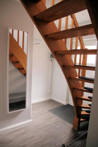 a staircase in a house with a mirror at Kleeblatt in Fehmarn