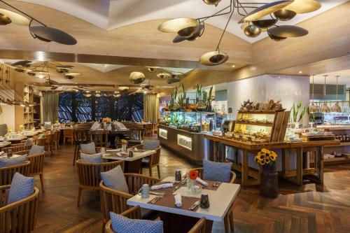 a restaurant with tables and chairs and a bar at Intercontinental Real Guatemala by IHG in Guatemala
