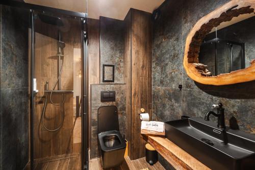 a bathroom with a sink and a toilet at Уютно Студио Verde Suites 07 in Blagoevgrad