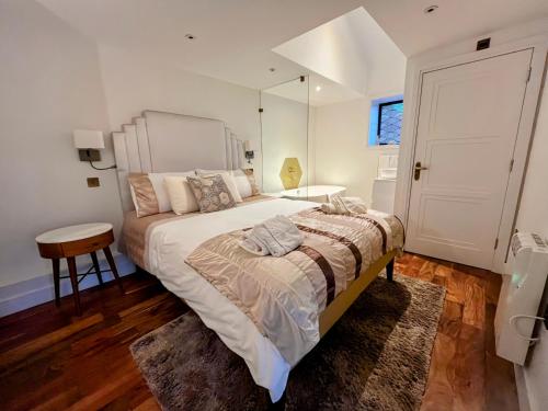 a bedroom with a large bed and a mirror at New Forest Fordingbridge - Art Deco Unique Apartment in Fordingbridge