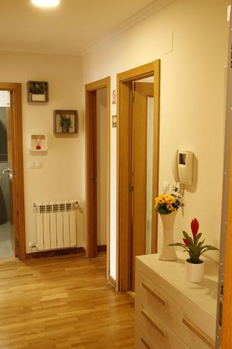 a living room with a hallway with a room with a radiator at Pensión A Solaina in O Pedrouzo