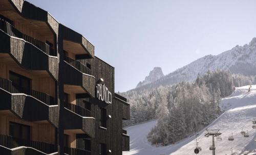 a hotel with a view of a snow covered mountain at Haunold Homes in San Candido