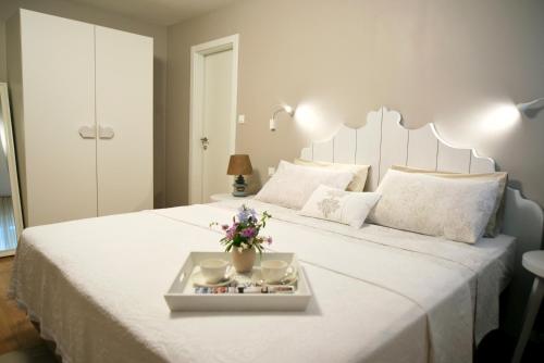 a bedroom with a large white bed with a serving tray on it at Villa Celine in Postira
