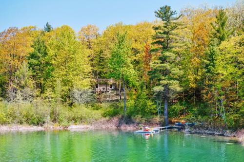 a boat on a lake in the middle of a forest at Lake Front-fishing-all sports Bass Lake Sanctuary in Traverse City