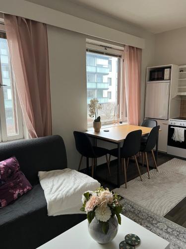 a living room with a couch and a table at Kaarlelankatu Studio in Kokkola