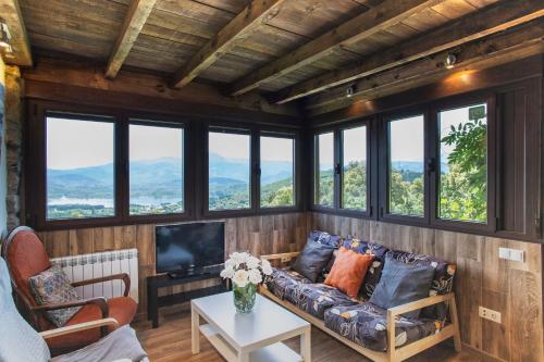 a living room with a couch and a tv at Ruralmedulas Casa 4 in Carucedo