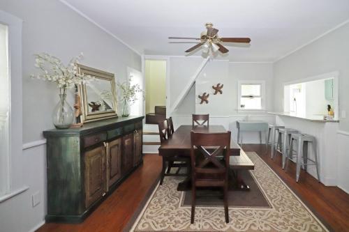 a dining room with a table and a ceiling fan at Hill House - Pet friendly, In town with water views! in Chincoteague