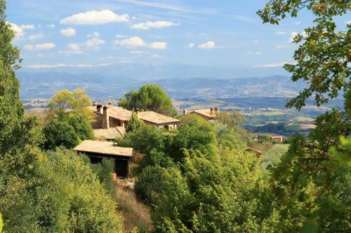 a house on top of a hill with trees at Wohnung Sonnenaufgang In Monte Vibiano Vecchio in Monte Vibiano Vecchio