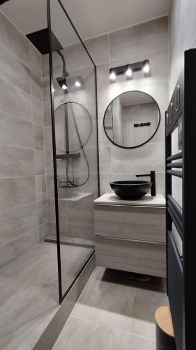 une salle de bain avec un lavabo et un miroir dans l'établissement Zen et Mer à Deauville, Piscine, Parking, Wifi, à Deauville