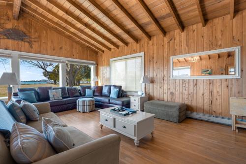 a living room with a couch and a table at Huntington Farm - Pristine Historical Home Overlooking Cherrystone Creek! in Cape Charles