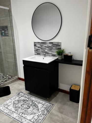 a bathroom with a sink and a mirror on the wall at Riverstone Studio - Self Catering in Cradock