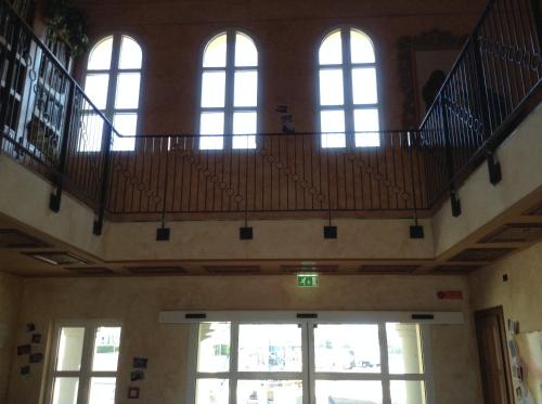 an empty room with a staircase in a building at Gardaland Adventure Hotel in Castelnuovo del Garda