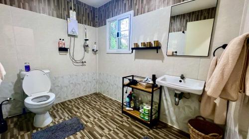 a bathroom with a toilet and a sink at Tiny Boutique House Koh Kood in Ban Lak Uan