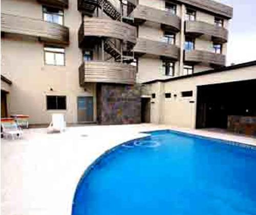 a large swimming pool in front of a building at Nuevo Mundo in San Rafael