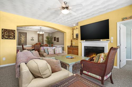 a living room with a couch and a tv at Isla Villa - Comfortable Bay Creek townhome with pools & golf! in Cape Charles