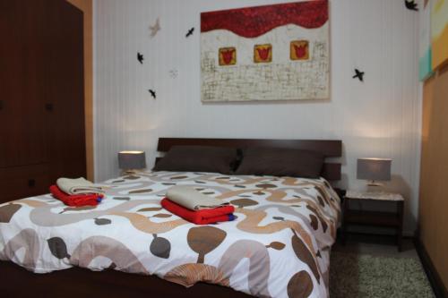 a bedroom with a bed with two phones on it at Casa HELI 1 in San Zeno di Montagna