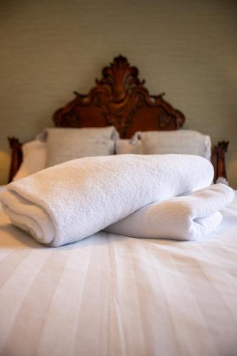 two towels are sitting on top of a bed at Harvest House with Games Room in Stirling