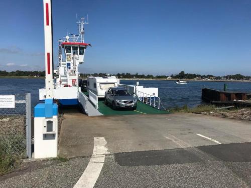 a car is on a ferry in the water at Beautiful Home In Ørsted W- in Ørsted