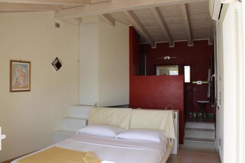 a white bed in a room with a hallway at Appartamenti Mavino in Sirmione