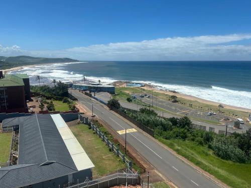 an aerial view of a road next to the ocean at Beachfront Apartment in Scottburgh
