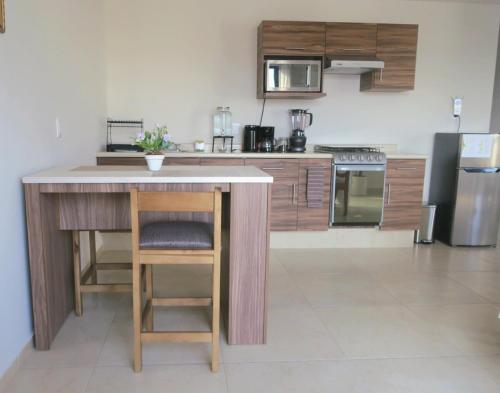 a kitchen with a island in the middle of a room at Departamento Tequis, totalmente nuevo en el corazón de SLP in San Luis Potosí