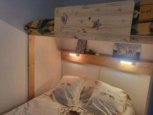 a bedroom with a bunk bed with two pillows at Superdévoluy Les Issarts in Superdevoluy