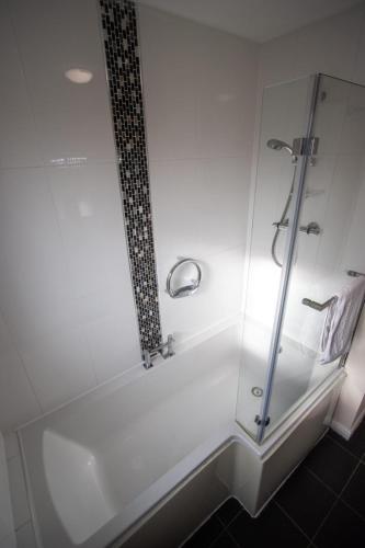 a bathroom with a shower with a glass enclosure at Harvest House with Games Room in Stirling