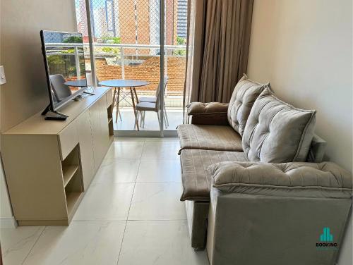 a living room with a couch and a tv and a table at Aquarius Style by Holiday Stays in Fortaleza