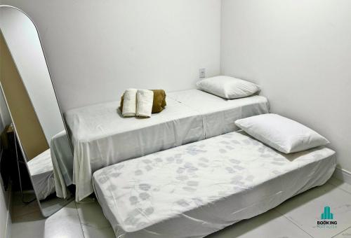 two beds in a room with white walls at Aquarius Style by Holiday Stays in Fortaleza