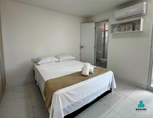 a bedroom with a bed with towels on it at Aquarius Style by Holiday Stays in Fortaleza