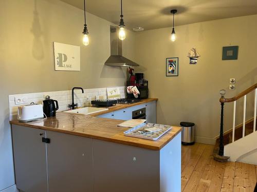 a kitchen with a sink and a counter top at Ty Jeanne classé 3 étoiles in Ploubazlanec