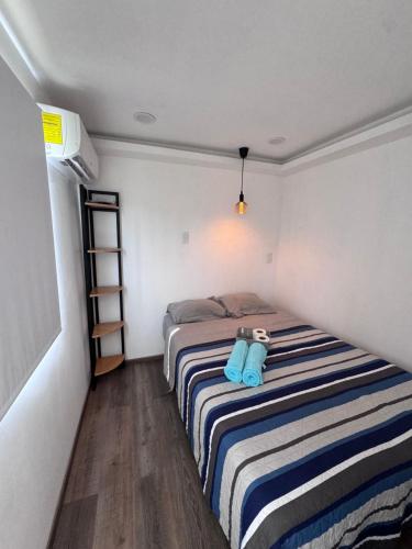 a bedroom with a bed with a stuffed animal on it at Hotel Playa Los Angeles Bungalow Aloha in Ciudad del Carmen