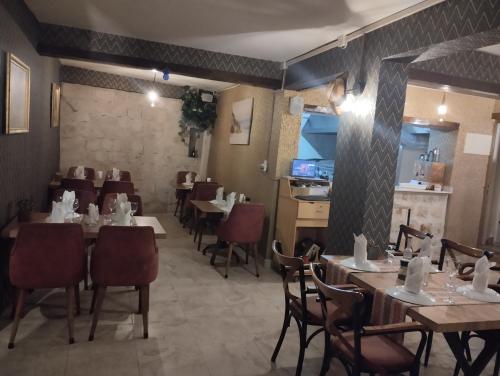 a restaurant with tables and chairs in a room at grand friends in Antalya